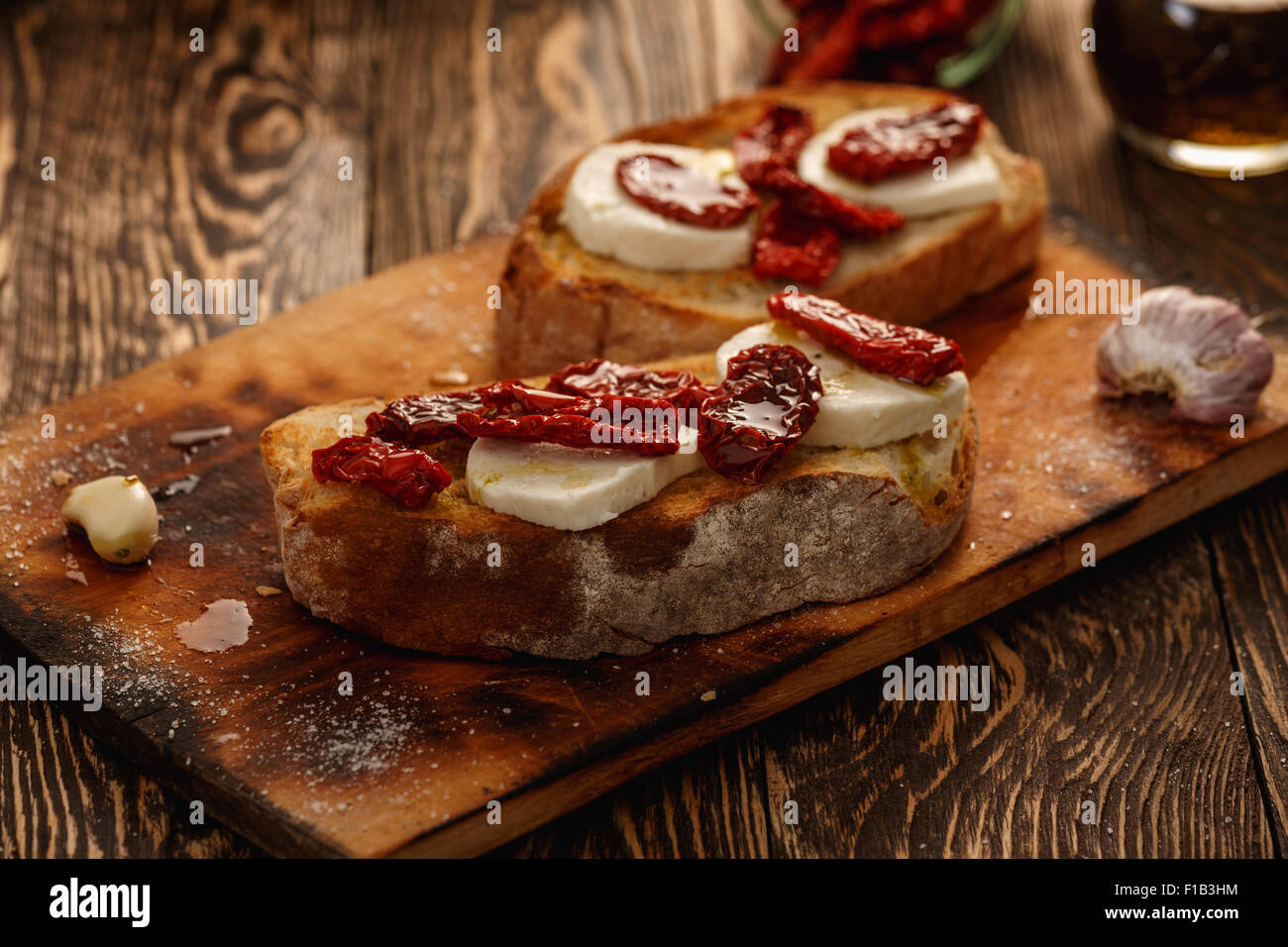 Bruschetta with dried tomatoes, mozzarella, garlic and olive oil