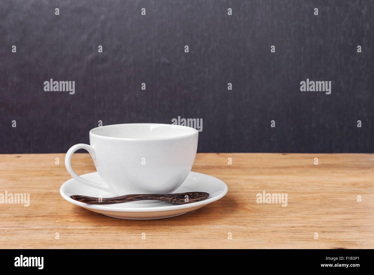 White cup of a coffee on a wooden background Stock Photo