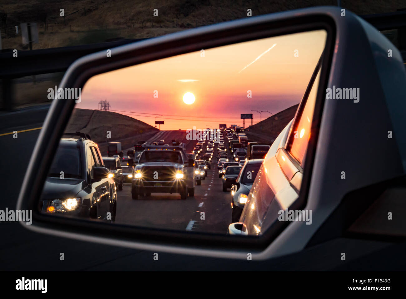 Sunrise in the rear view mirror Stock Photo - Alamy