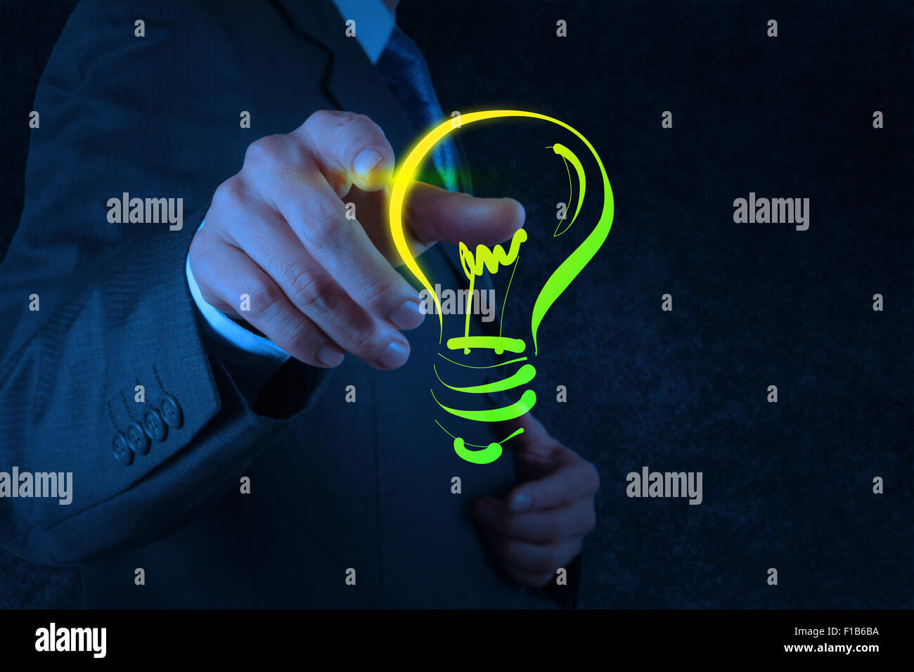 businessman hand with a pen drawing light bulb as concept Stock Photo ...