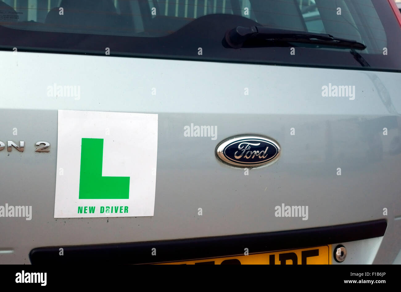 Green new driver L plate on a Ford car UK Stock Photo