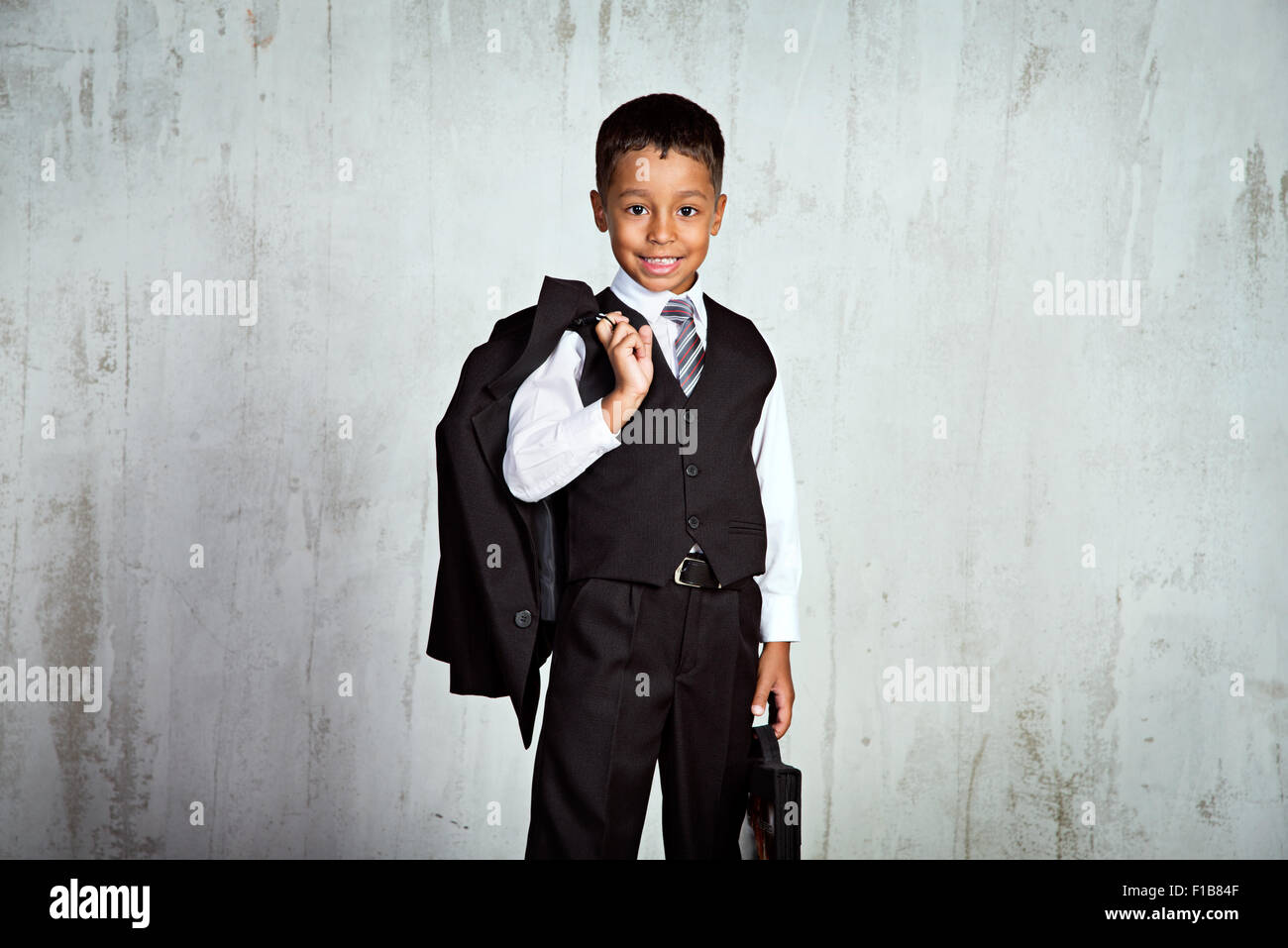 Smiling black firstgrader african boy in school uniform with the
