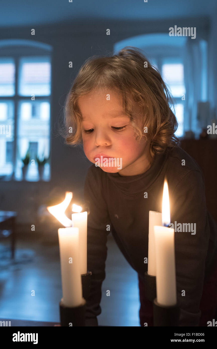 Little girl blowing out candles Stock Photo Alamy