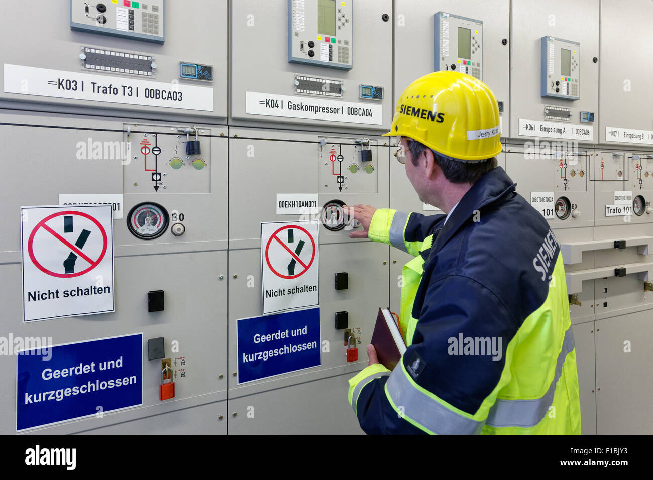 Ludwigsfelde, Germany, Siemens technicians in the electrical control room of the Clean Energy Center Stock Photo