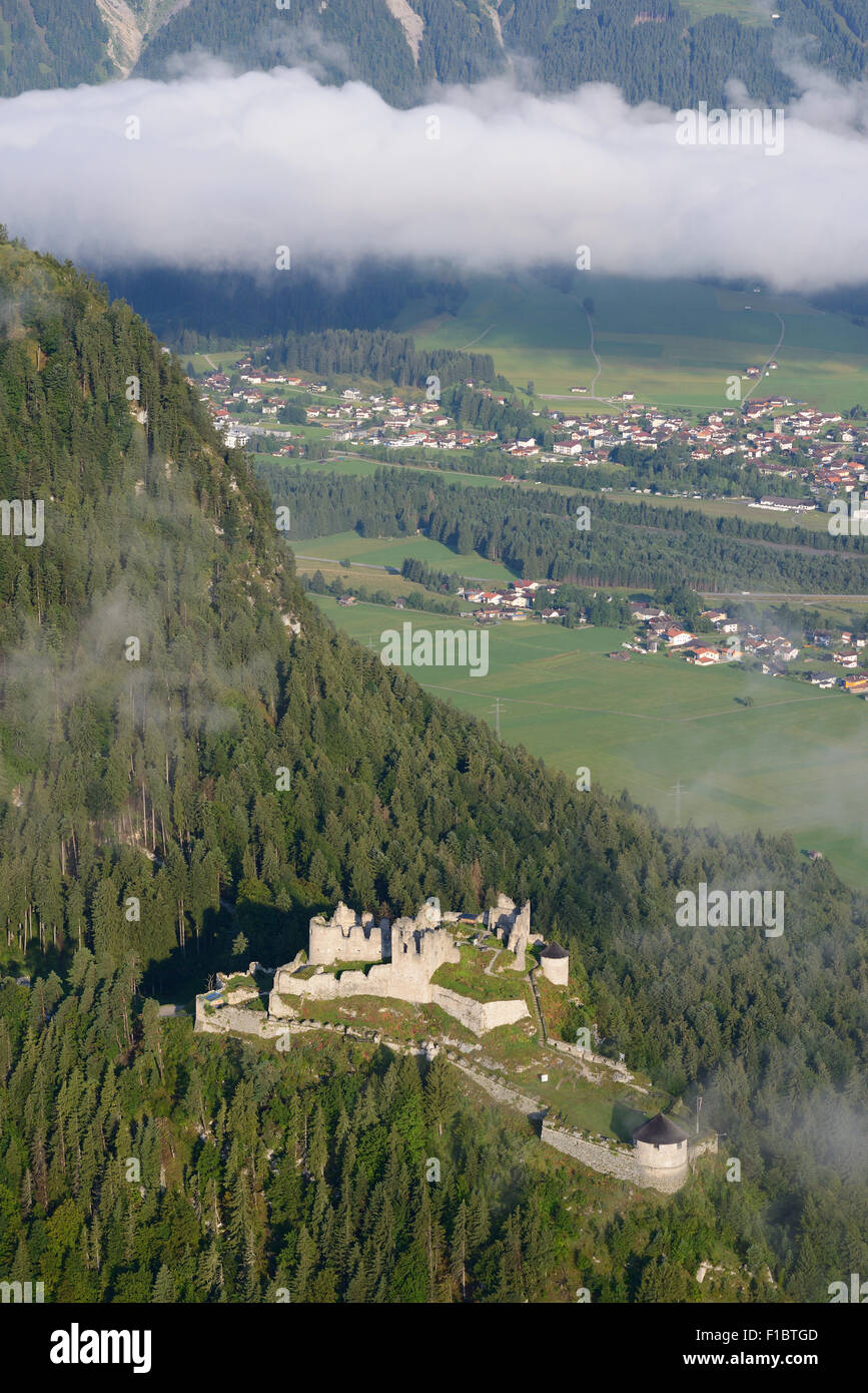 AERIAL VIEW. Ehrenberg Castle with some morning fog overlooking the Lech Valley. Klause, Reutte, Tyrol, Austria. Stock Photo