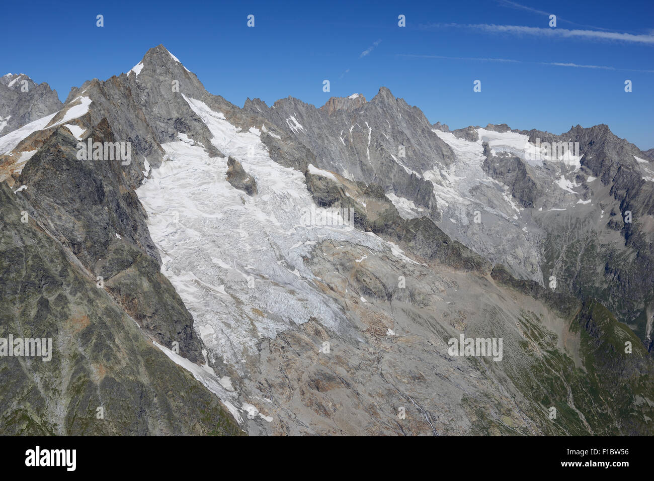 AERIAL VIEW. Tripoint of France, Italy and Switzerland at the summit of Mont Dolent. Swiss side of the mountain, Mont Blanc Massif. Stock Photo