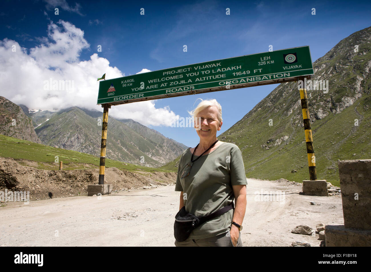 India, Jammu & Kashmir, Srinagar to Leh Highway, female western tourist at 11694 foot high Zojila Pass Stock Photo