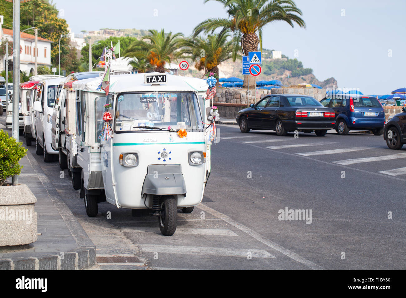 Casamicciola Terme, Italy - August 12, 2015: Micro taxi stand parked on a roadside, white Ape Car Stock Photo