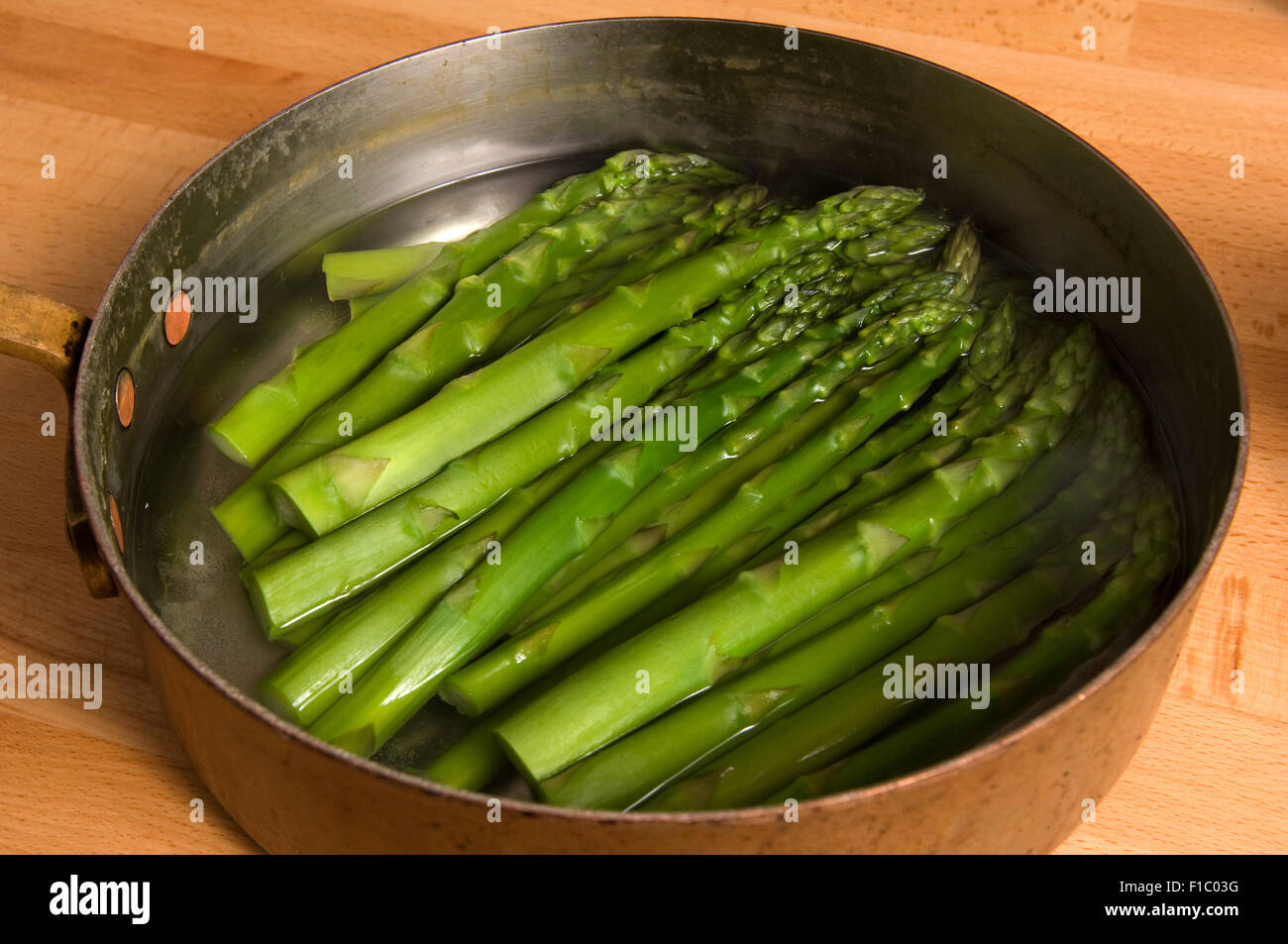 Asparagus boiled and served with butter. Stock Photo