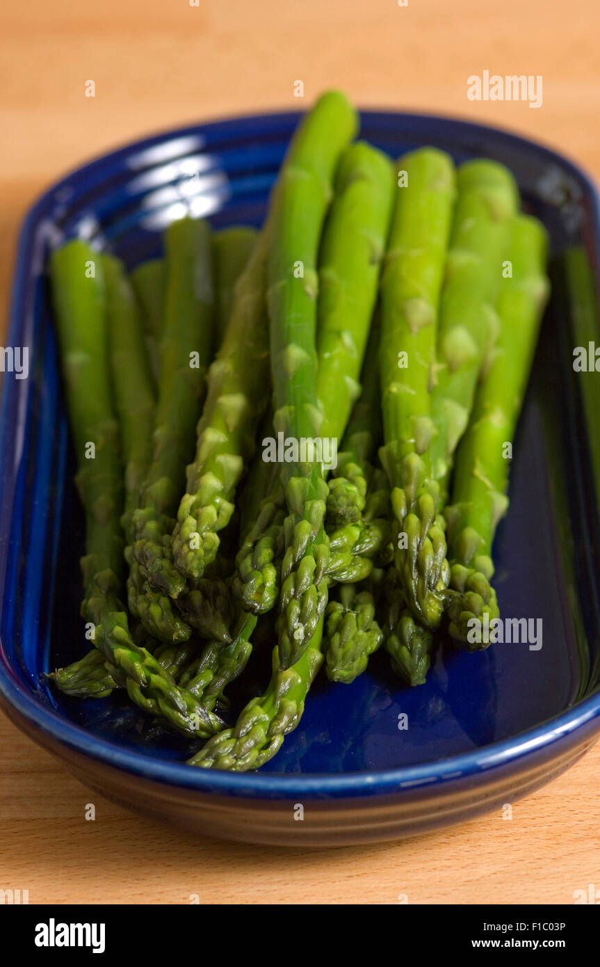 Asparagus boiled and served with butter. Stock Photo
