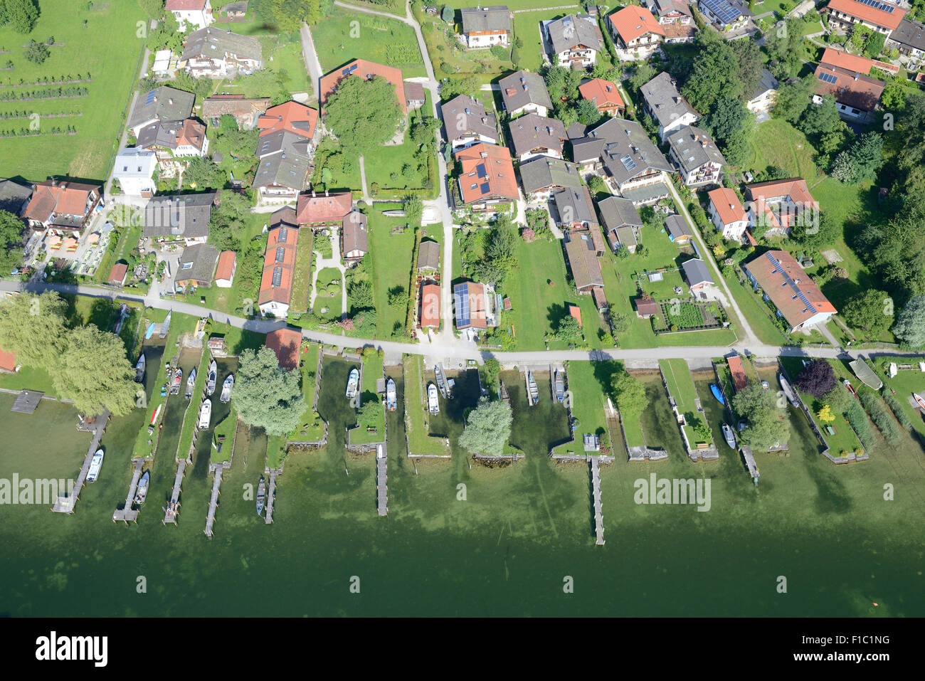 AERIAL VIEW. Private homes with their private docks. Fraueninsel (also known as Frauenchiemsee) Island, Lake Chiemsee, Bavaria, Germany. Stock Photo
