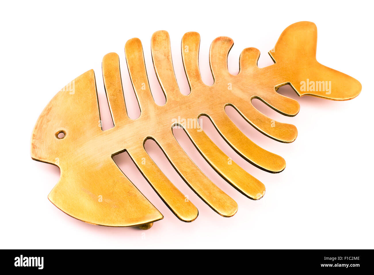 Brass fish mat - kitchen utensil isolated on white Stock Photo