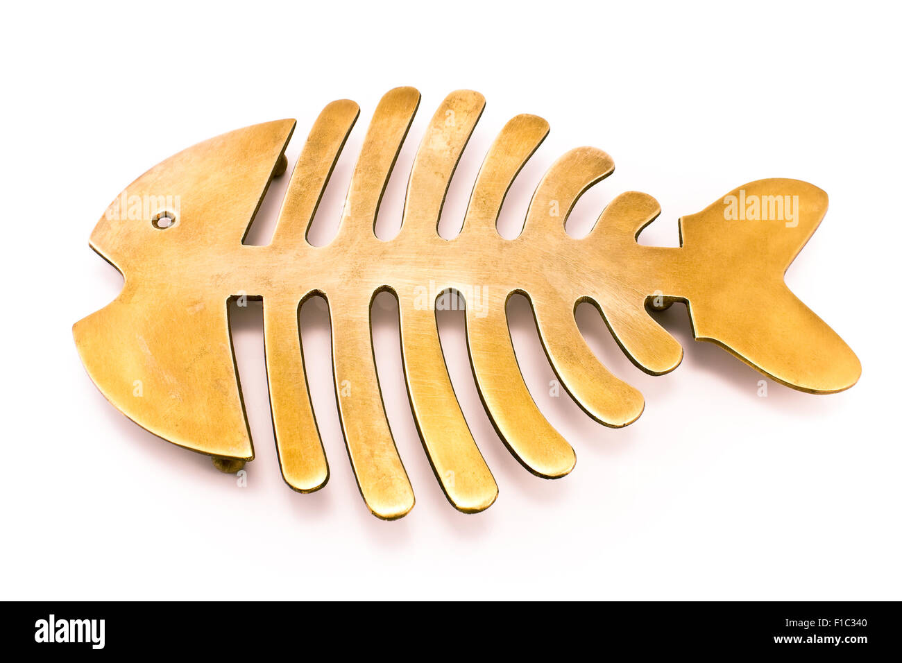 Brass fish mat - kitchen utensil isolated on white Stock Photo
