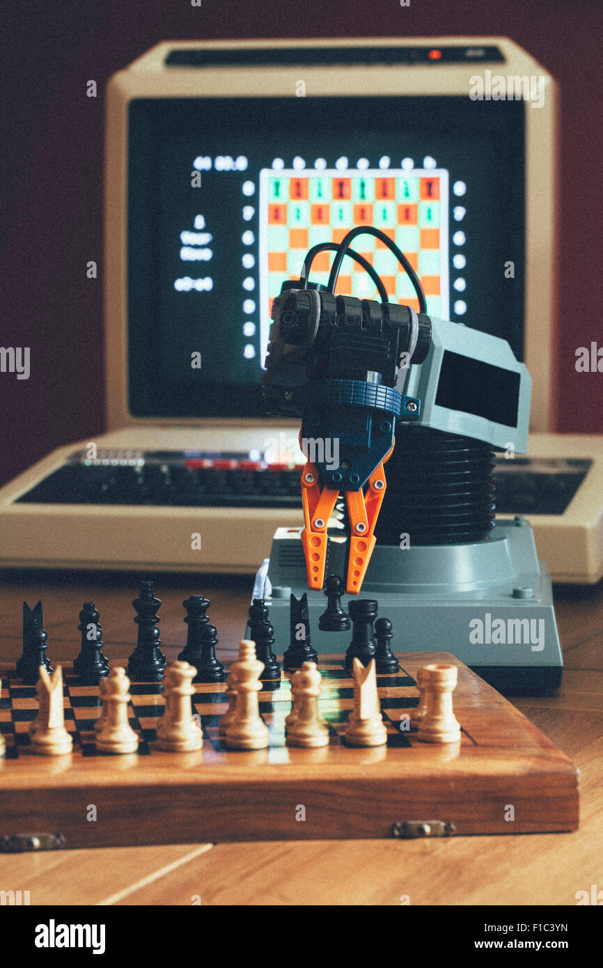Vintage / Retro Computer with Robot Arm playing a games of Chess Stock Photo
