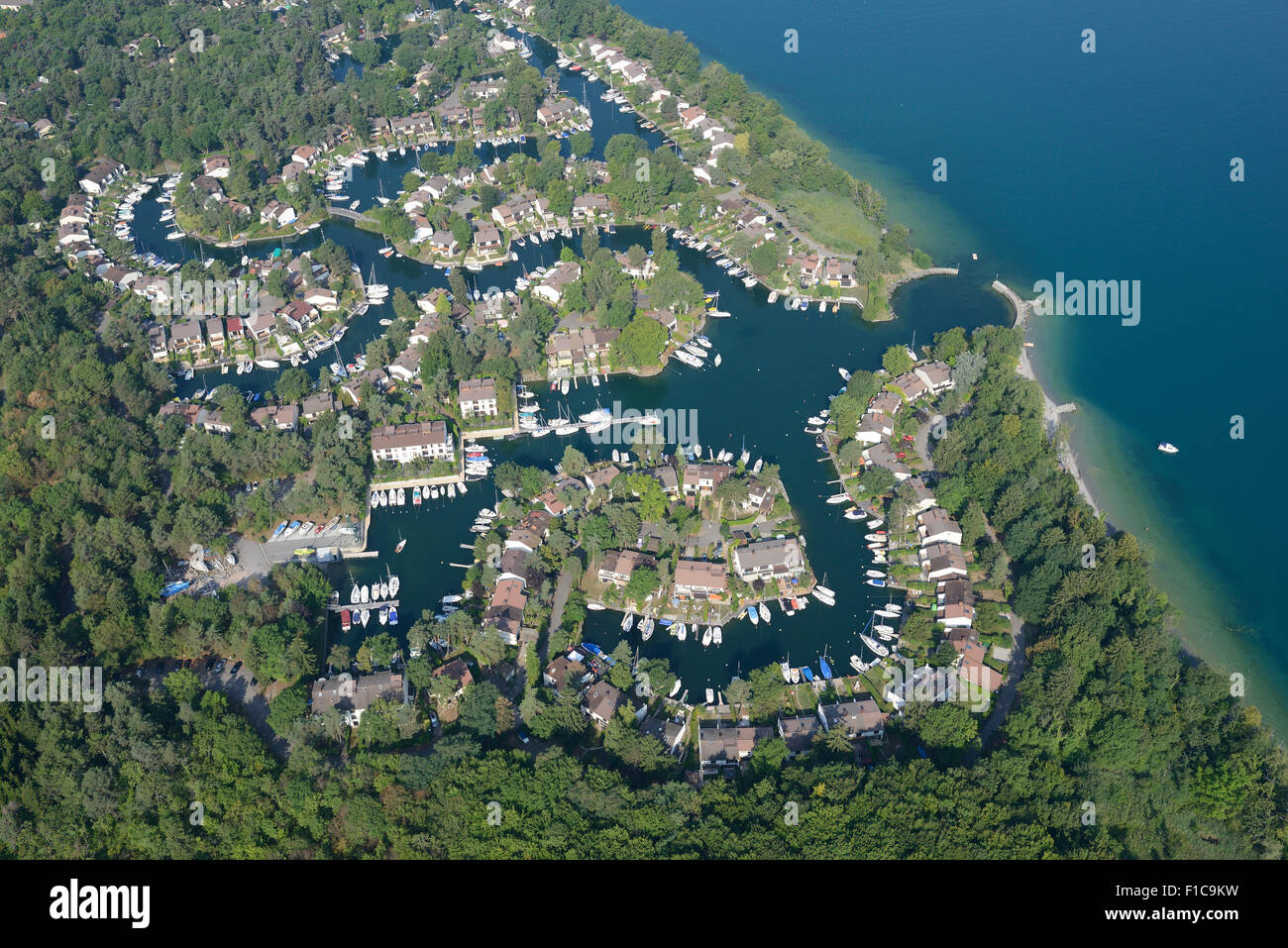 AERIAL VIEW. Marina with many residences, all having a private mooring. Port Ripaille, Lake Geneva, Haute-Savoie, Auvergne-Rhône-Alpes, France. Stock Photo