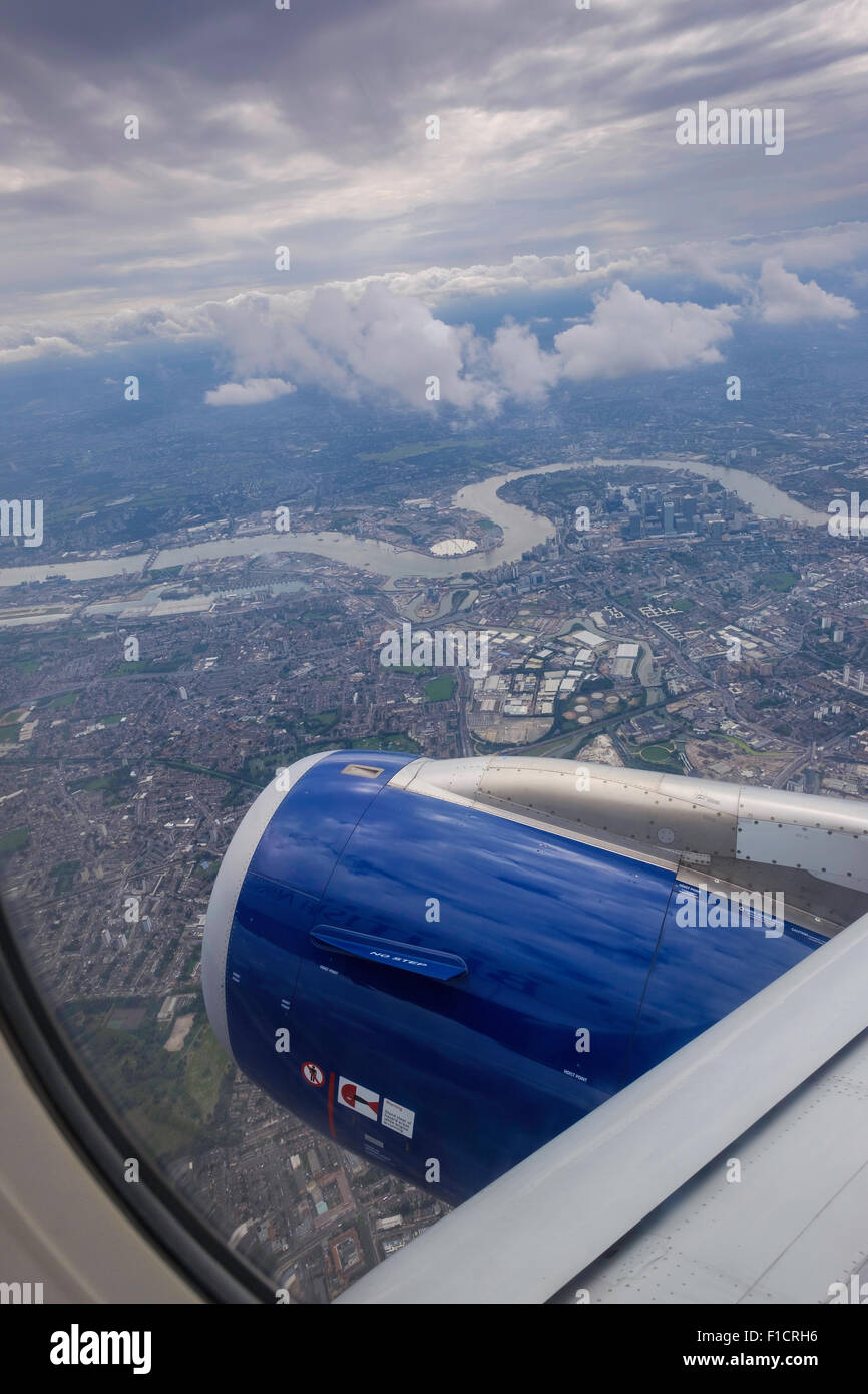 Aerial view from aircraft window Airbus 320  of London and River Thames with aerial view of O2 dome and houses. Stock Photo