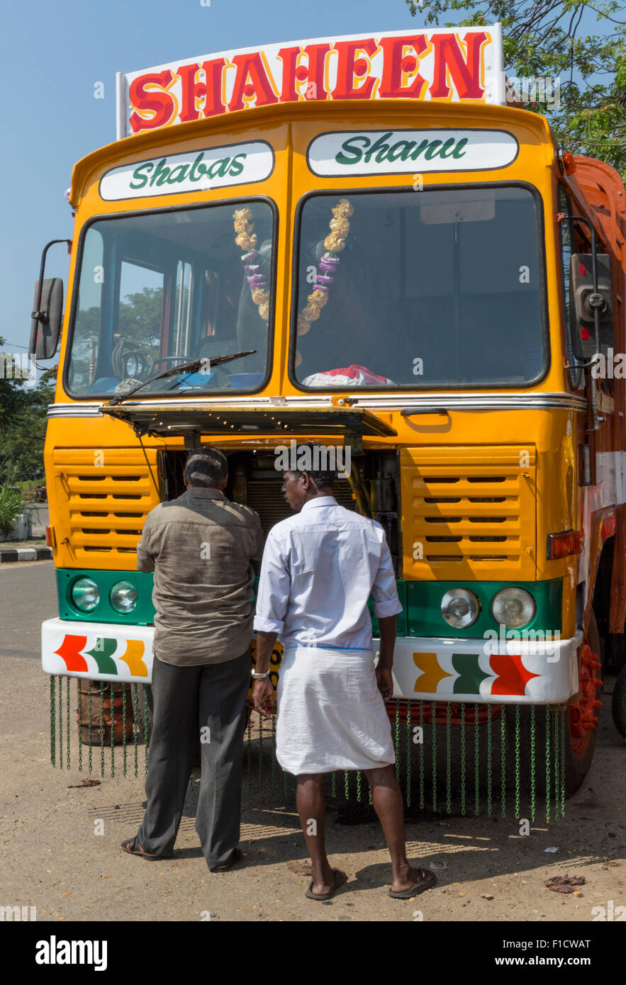 Truckers and decorated long distance truck parked by roadside in Kochi, Kerala, India Stock Photo