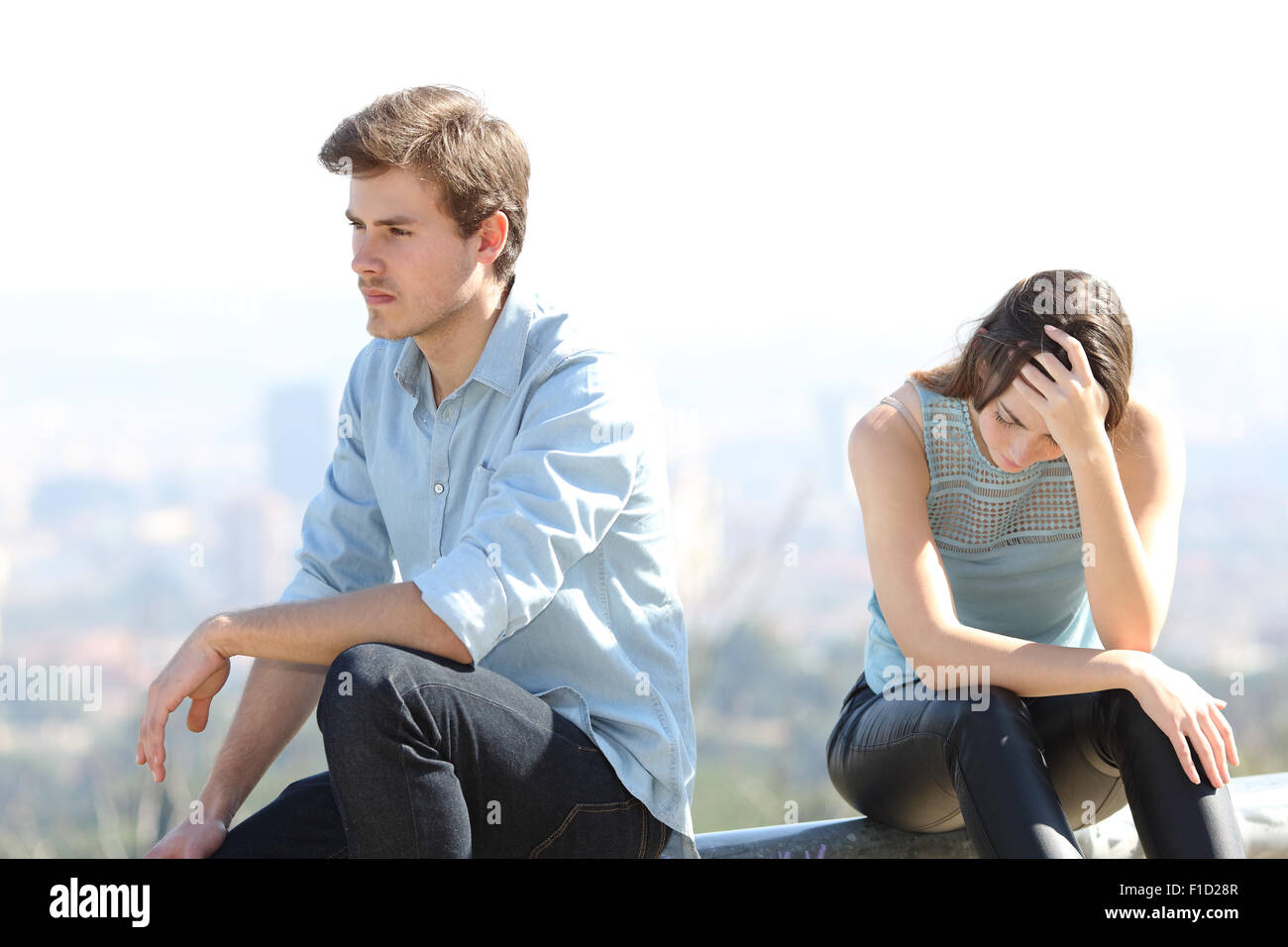 Bad boy arguing with his couple breakup concept with the city in the background Stock Photo