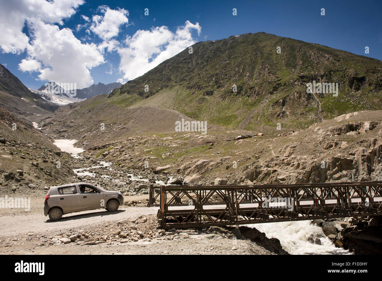 India, Jammu & Kashmir, Srinagar to Leh Highway, small car crossing Bailey Bridge over  Gumri glacier mountain stream meltwater Stock Photo