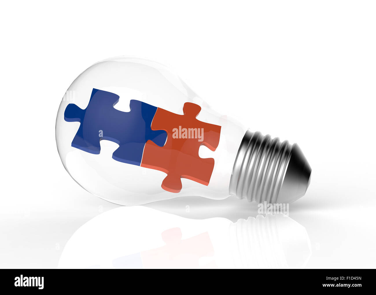 Light bulb and two puzzles as concept Stock Photo
