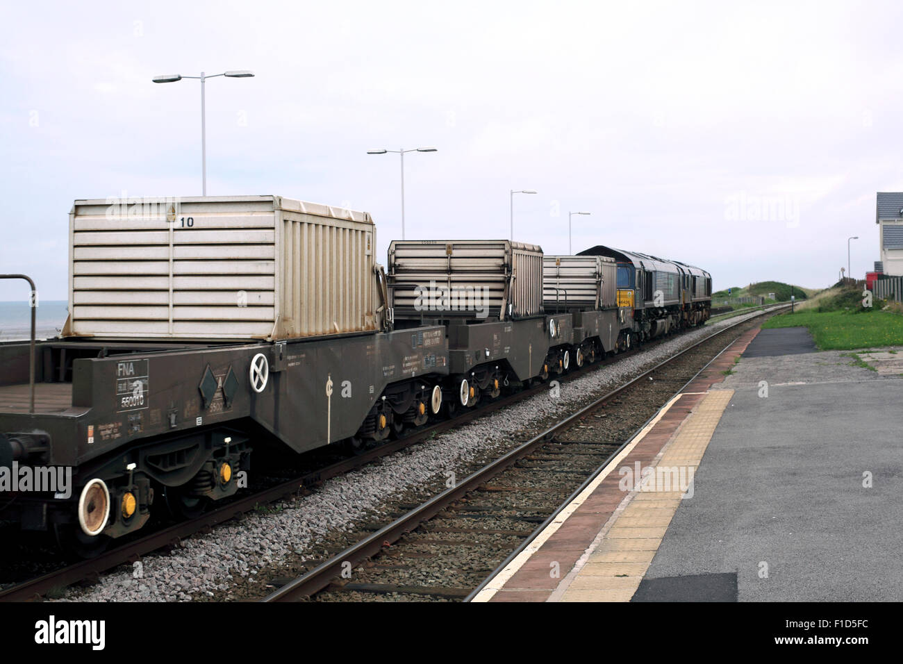 A train transporting three flasks of irradiated nuclear fuel ('nuclear waste') passes Seascale, Cumbria, en route to Sellafield. Stock Photo
