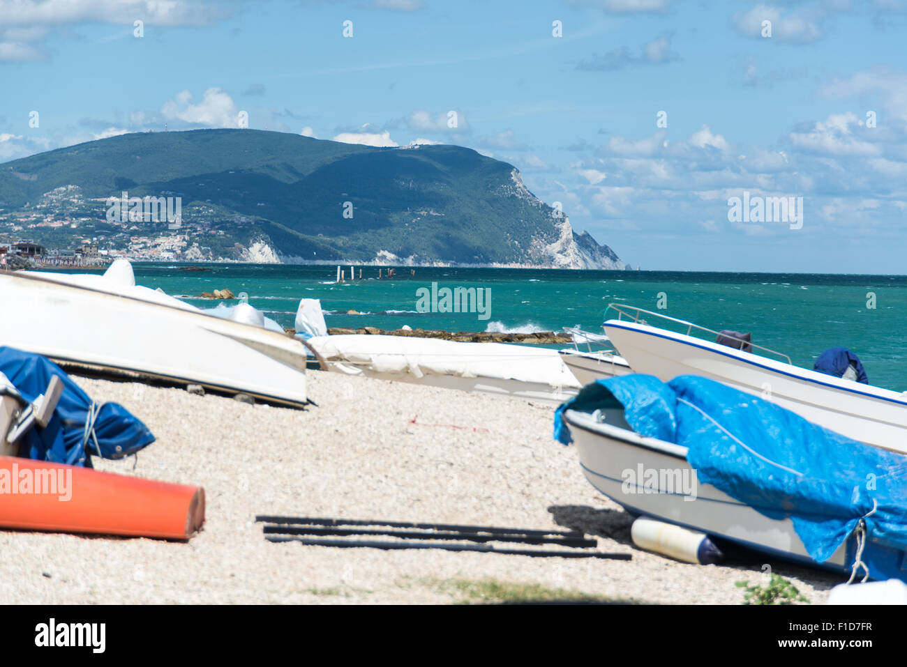 View of the Mount Conero, Ancona, from a beach in Numana, Italy, with boats Stock Photo