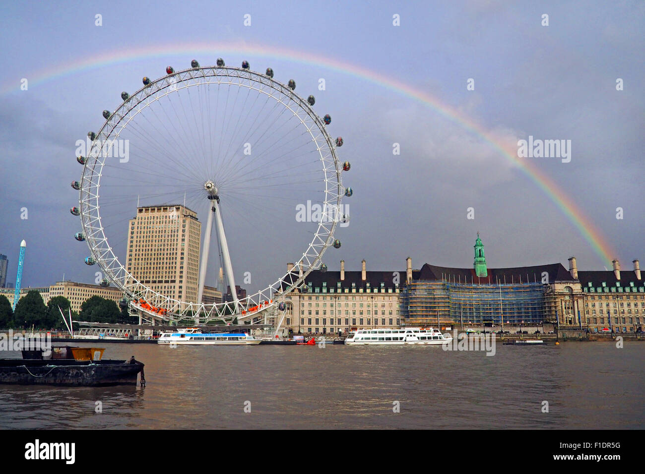 London, UK. 1st September, 2015. Changeable weather led to a beautiful rainbow stretching over the London Eye and the River Thames just before sunset in London Credit:  Paul Brown/Alamy Live News Stock Photo
