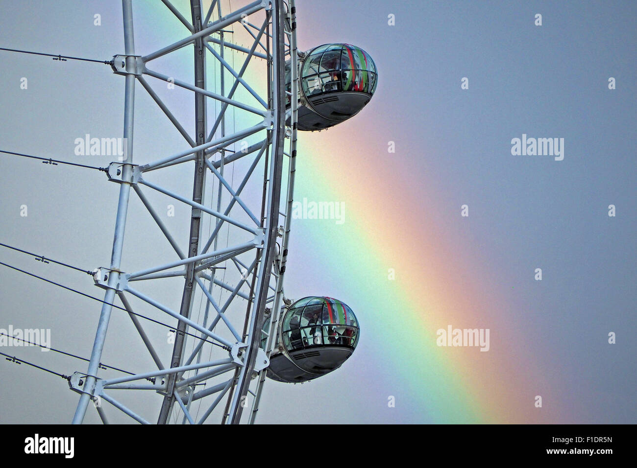 London, UK. 1st September, 2015. Changeable weather led to a beautiful rainbow stretching over the London Eye and the River Thames just before sunset in London Credit:  Paul Brown/Alamy Live News Stock Photo