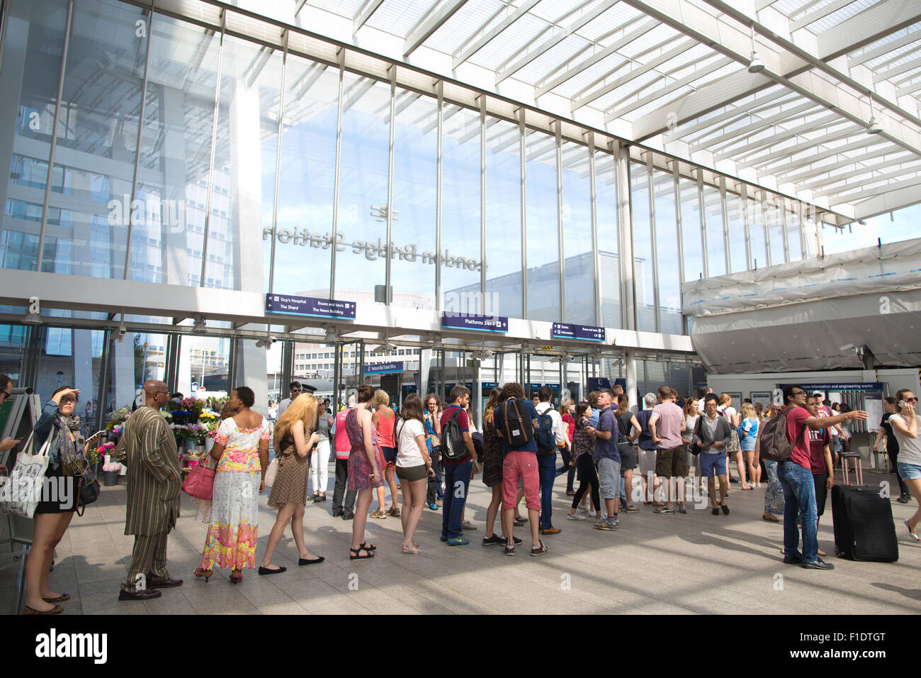 Queues of summer commuters lining up to purchase rail tickets at London Bridge train station, Central London, England, UK Stock Photo