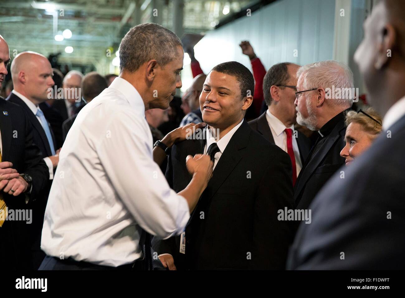 U.S. President Barack Obama greets Ramone Davis, a veteran who served tours in Afghanistan and Iraq and now works at Ford's Michigan Assembly Plant January 7, 2015 in Wayne, Michigan. Stock Photo