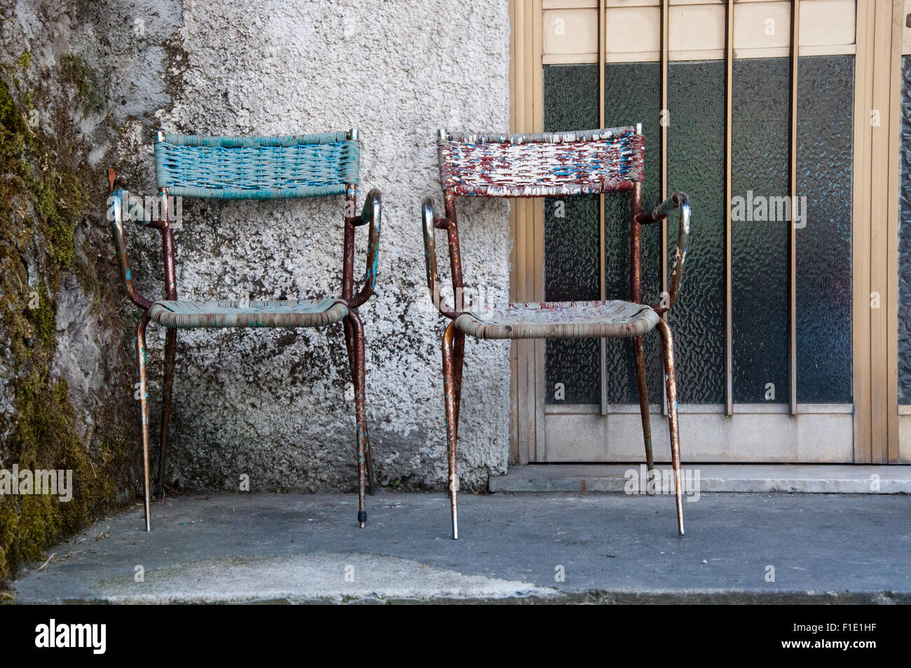 Restaurant entry with 2 chairs at  front door, Alpuan Alps, Tre Fiumi, Tuscany, Italy Stock Photo