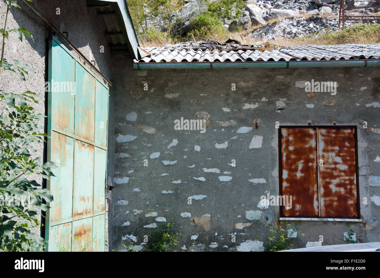 Garage in Alpuan Alps, Tre Fiumi, Tuscany, Italy, with run-down, neglected facade Stock Photo