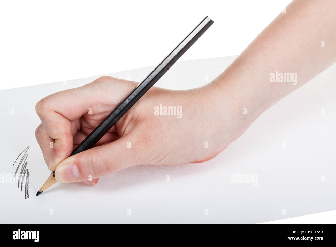hand paints by wood black pencil on sheet of paper isolated on white ...