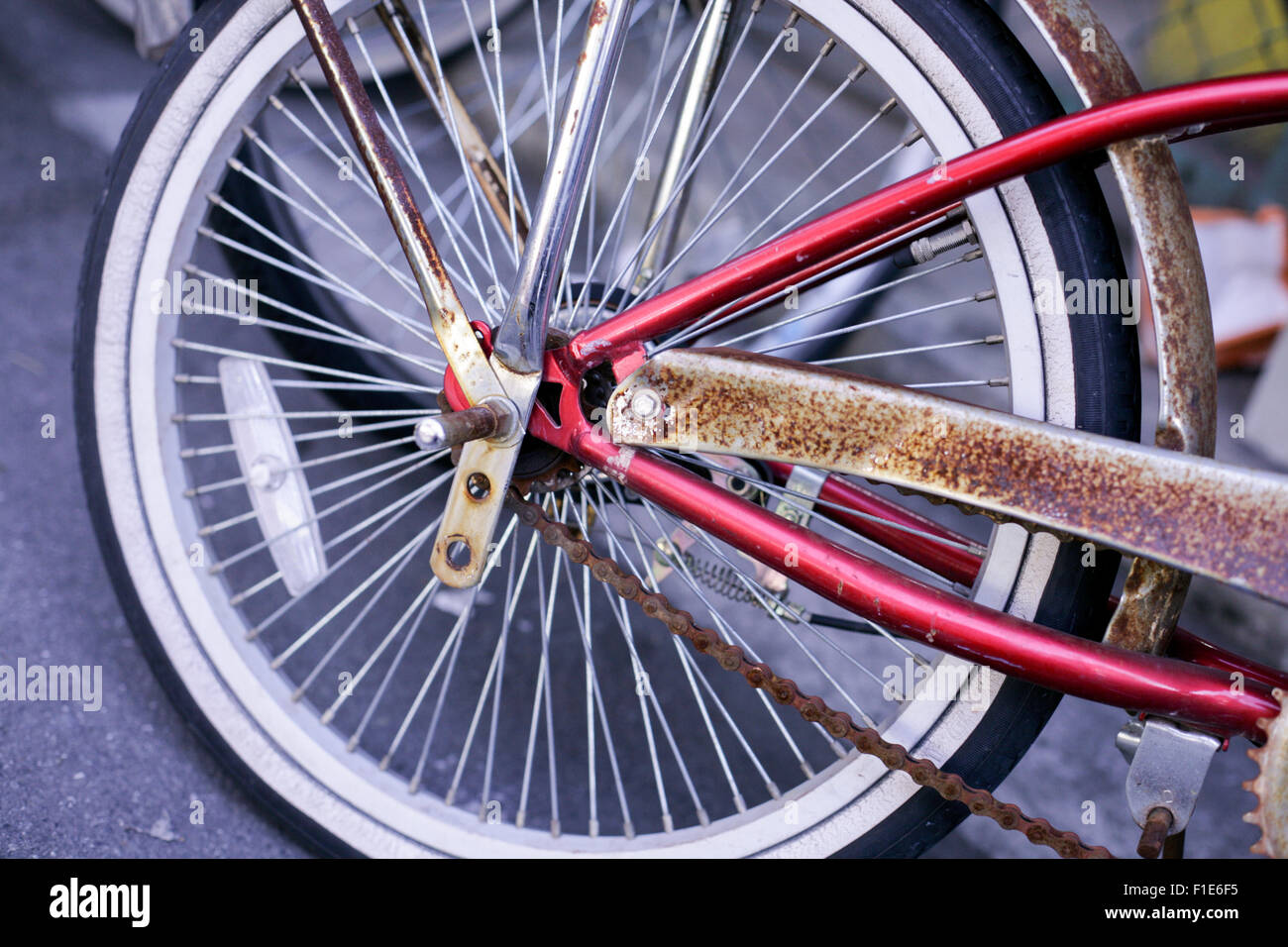 White wall bicycle wheel with wire spokes with rusty chain Stock Photo