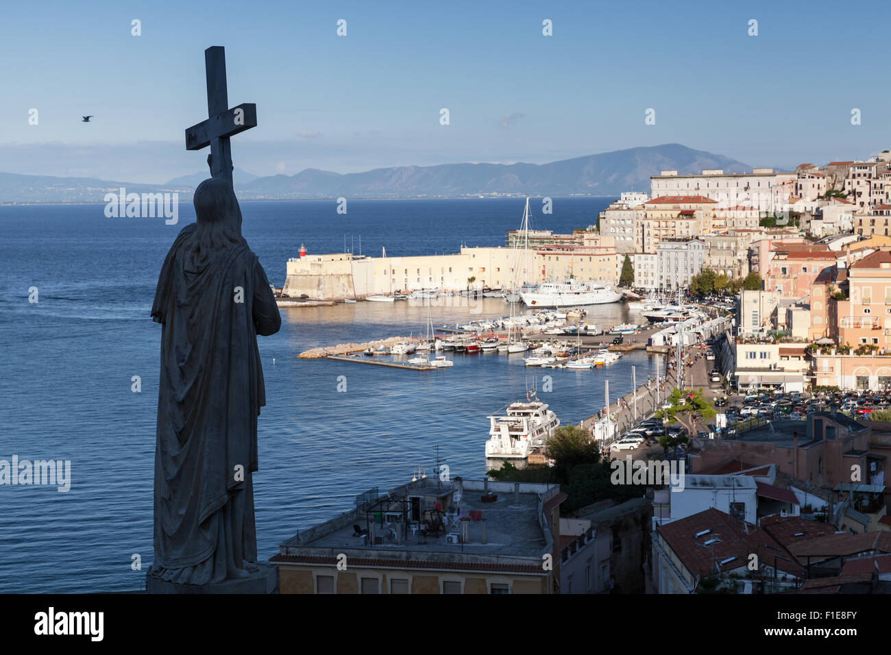 Silhouette of Jesus Christ statue with cross as a part of Saint Francesco Cathedral exterior and historic quarter of Gaeta town, Stock Photo