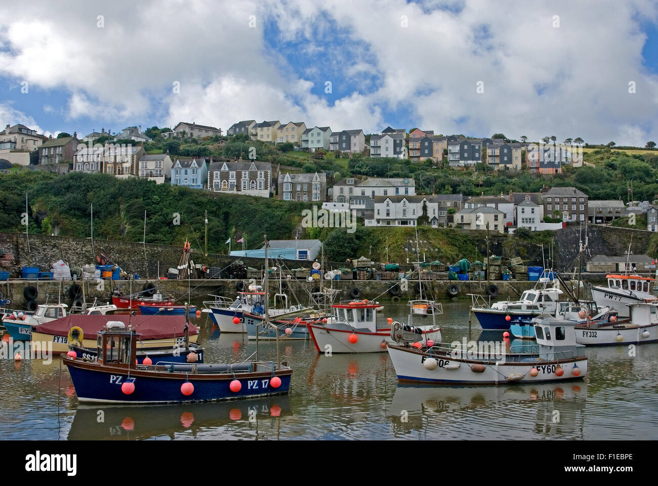 Cornwall coast line and the fishing village of Mevagissey with colourful fishing boats in the working harbour. Stock Photo
