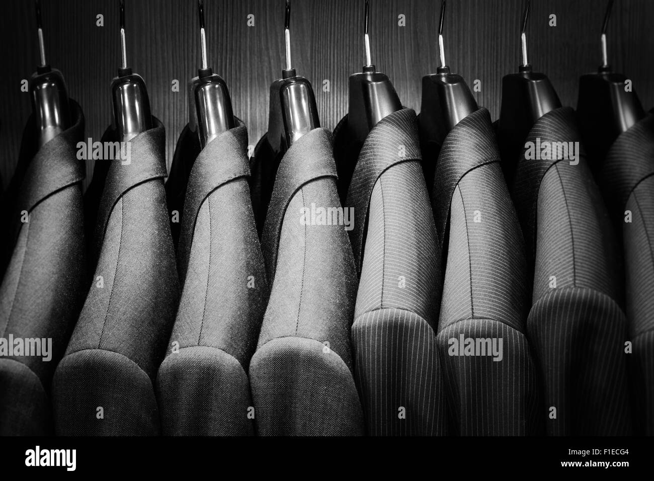 Row of men suit jackets. Black and white image. Stock Photo