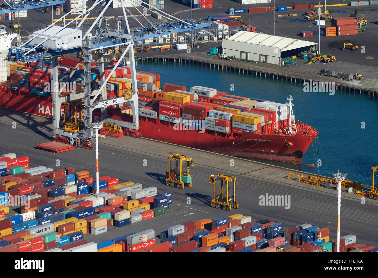 Ship and containers at Ports of Auckland, Auckland, North Island, New Zealand - aerial Stock Photo