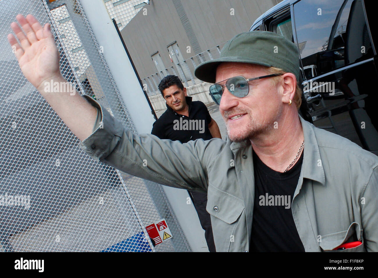 Turin, Italy. 01st Sep, 2015. Bono greets his fans. Bono Vox, the frontman of the Irish rock band U2 arrives at the Olympic Stadium where hundreds of their fans wait for press conference and autograph signing. Credit:  Elena Aquila/Pacific Press/Alamy Live News Stock Photo