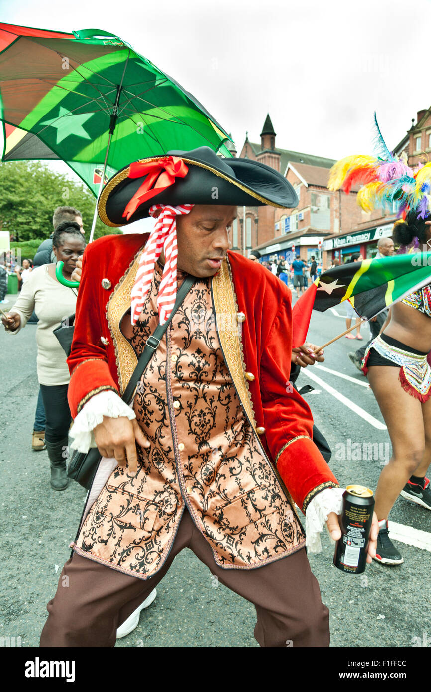 Leeds, UK. 31st Aug, 2015. A man dressed in a carnival costume dances