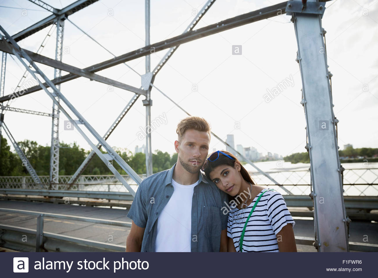 Portrait serious couple on bridge Stock Photo