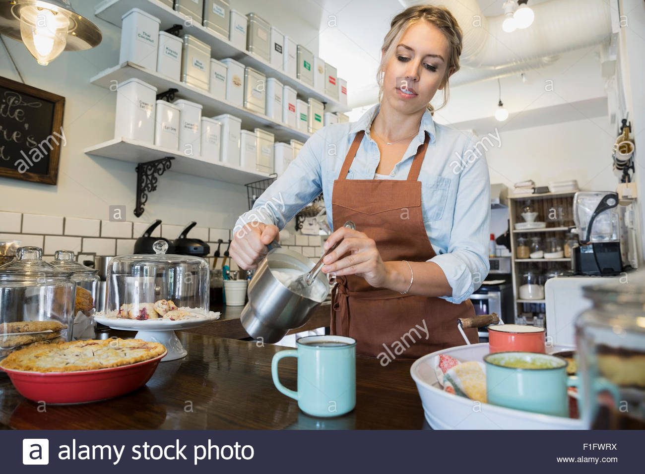 Bakery owner pouring tea at counter Stock Photo Alamy