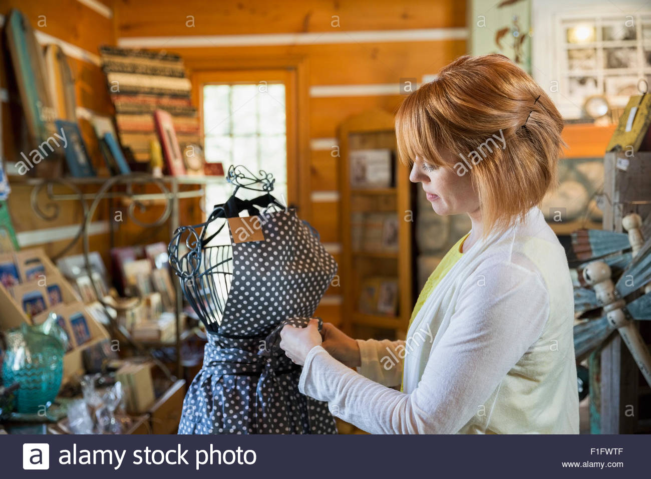 Shop owner preparing apron display Stock Photo