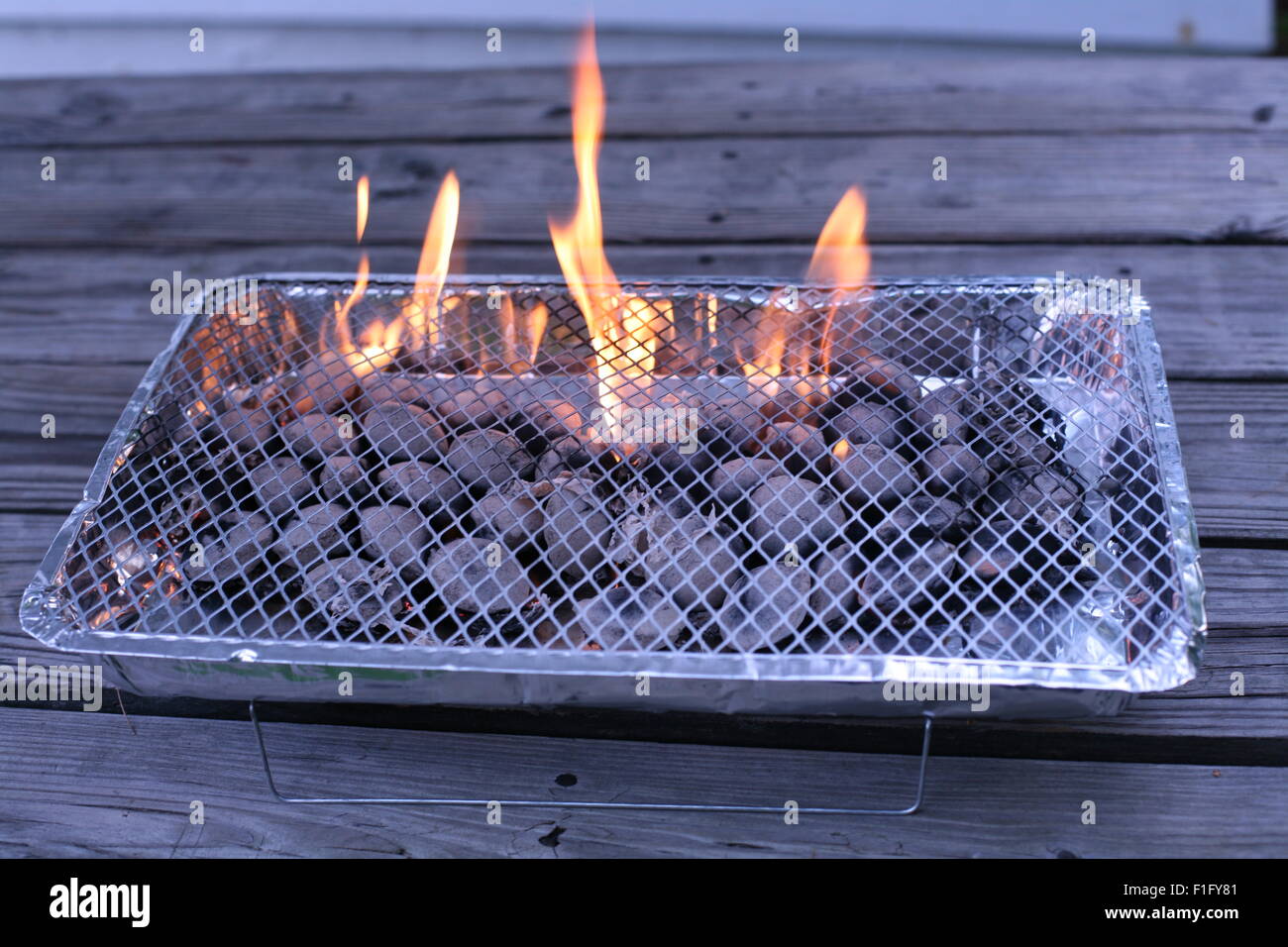 disposable grill with charcoals burning Stock Photo Alamy