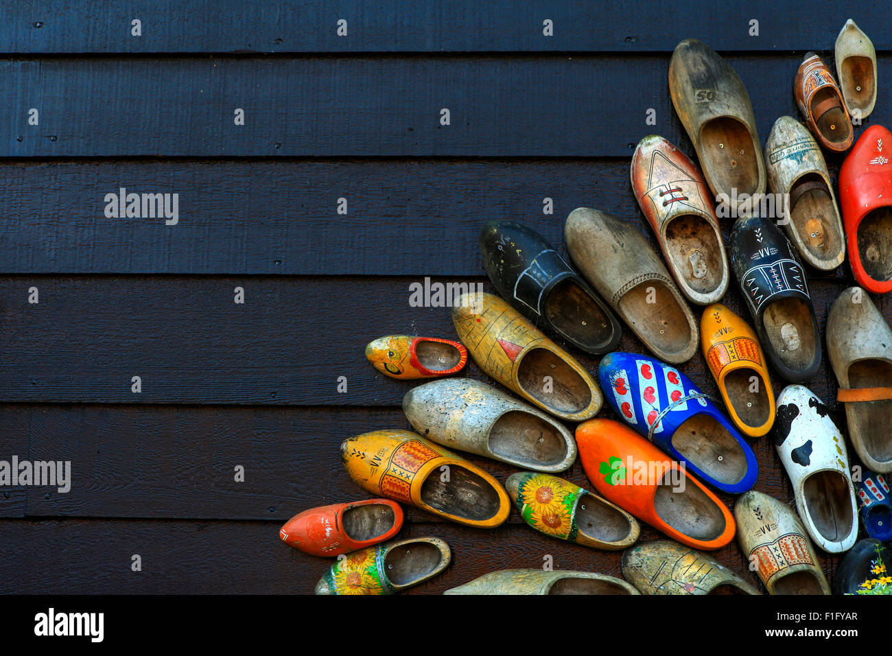 Colorful wooden clogs on dark wooden panels Stock Photo