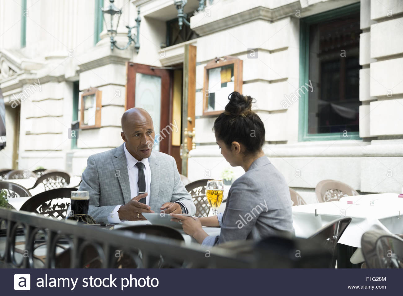 Business people working on pub patio Stock Photo Alamy