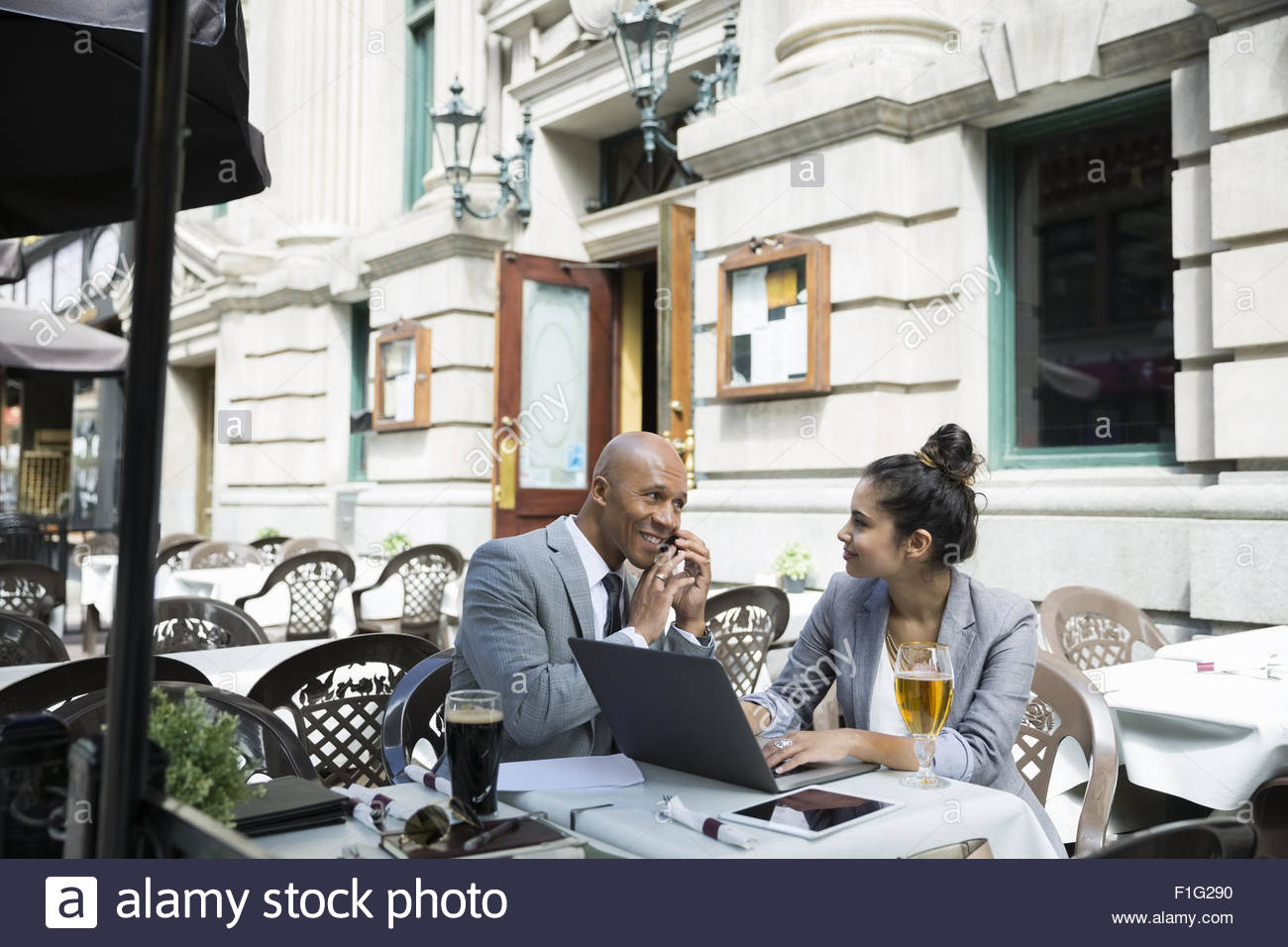 Business people working at table on pub patio Stock Photo Alamy