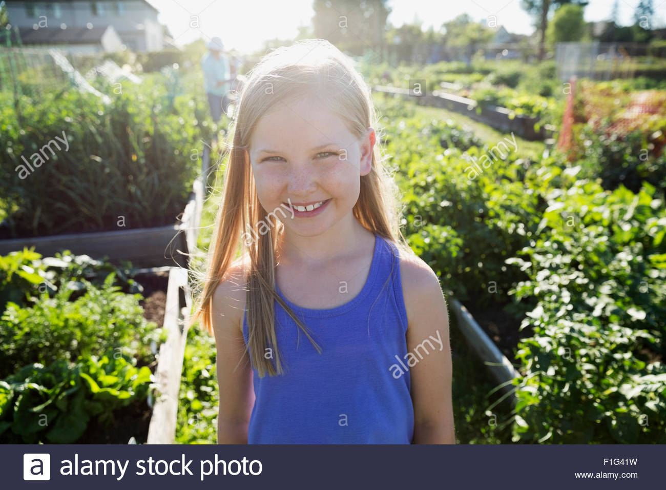 Portrait smiling girl in sunny garden Stock Photo