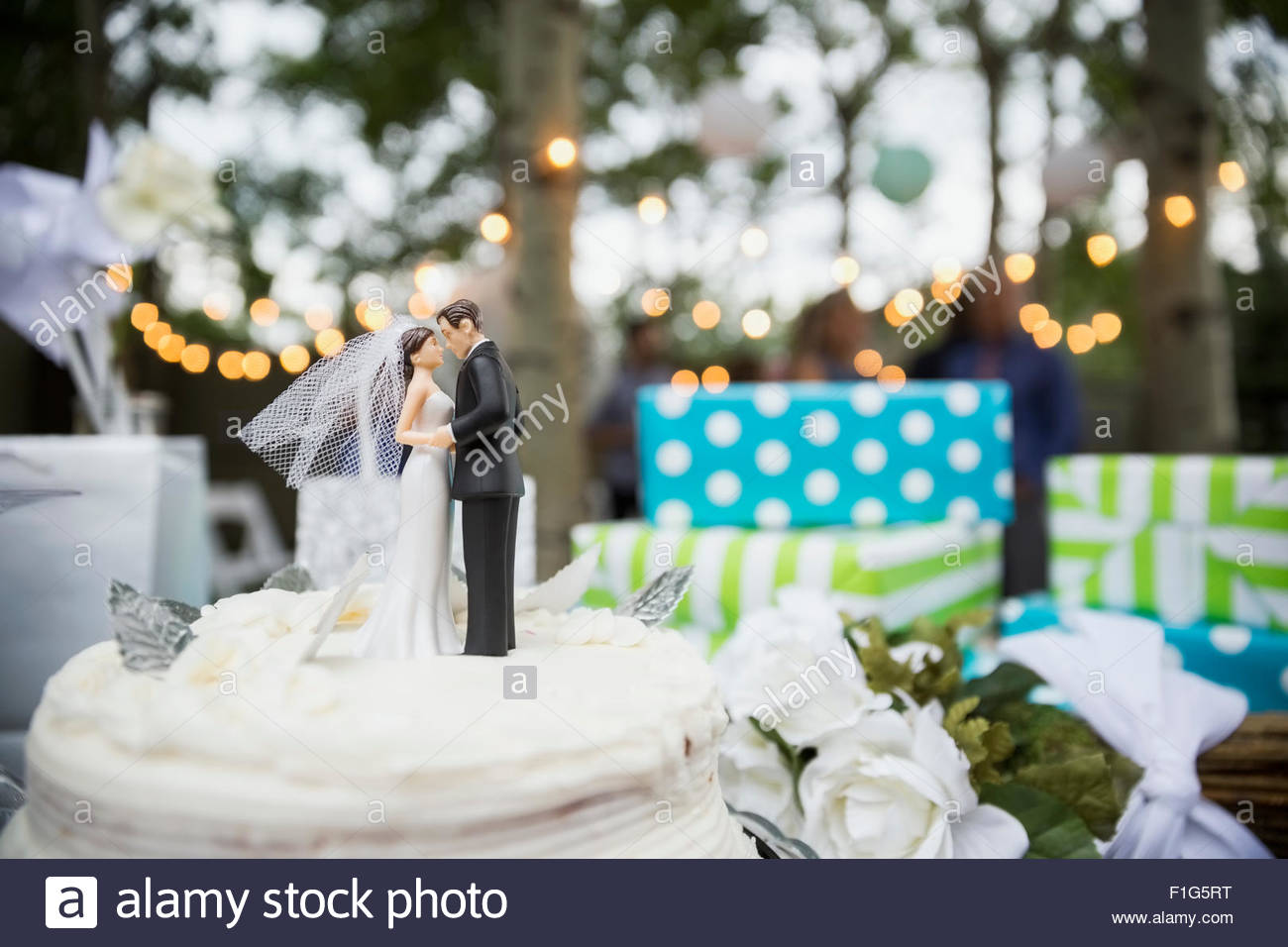 Bride and groom cake topper on cake Stock Photo