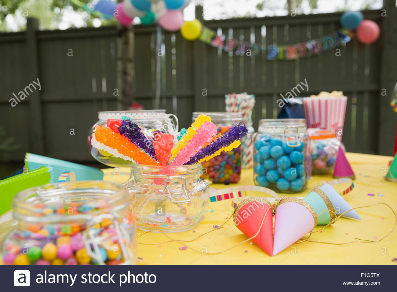 Candy party hats on birthday party table backyard Stock Photo